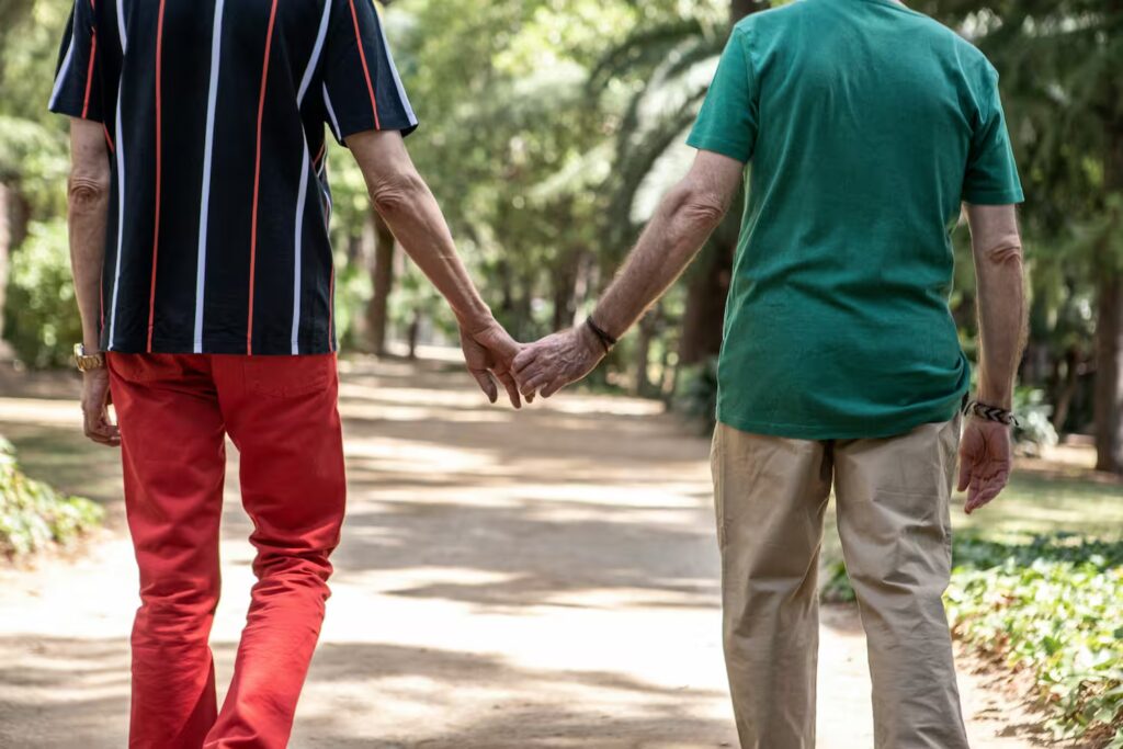 Gay couple holding hands, working together through resistance in their relationship.